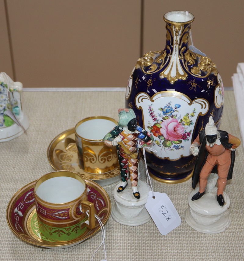 A Royal Crown Derby vase, a pair of Neapolitan Commedia dellArte figures and two Vienna style coffee cans and saucers
